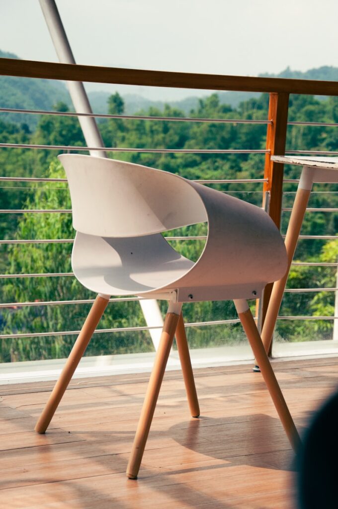 A white chair sitting on top of a wooden floor