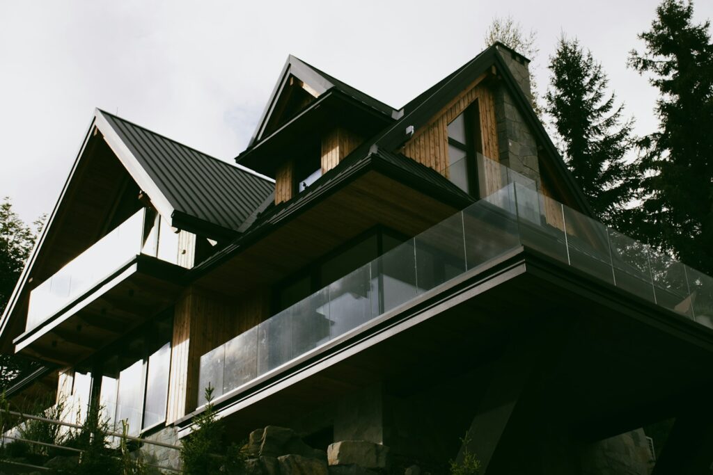 a house with a metal roof and a glass balcony